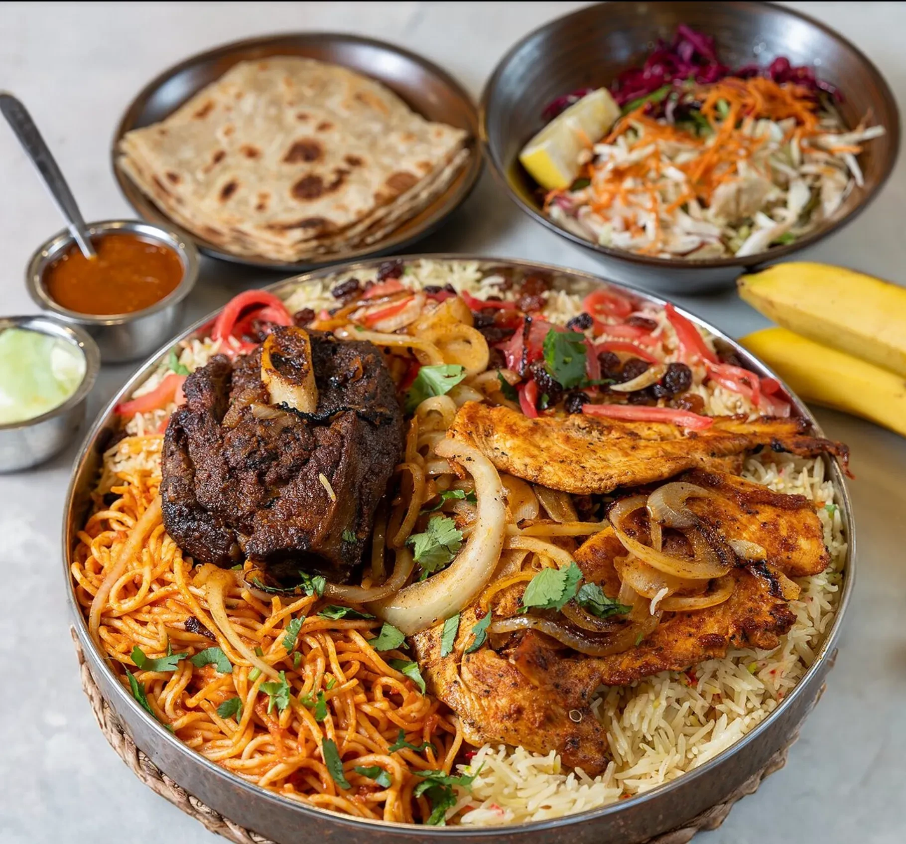 The Salaama sharing platter — rice, baasto, goat shank and grilled chicken