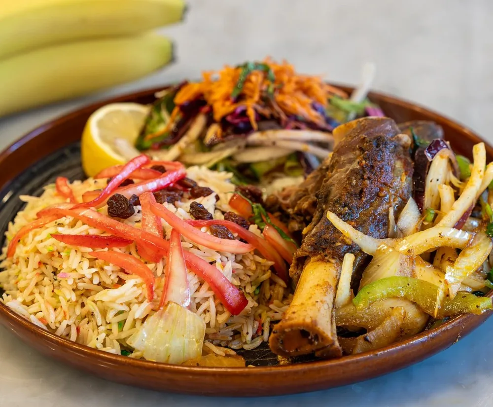 Haneeth — rice with raisins and sweet pepper, served with tender meat and salad