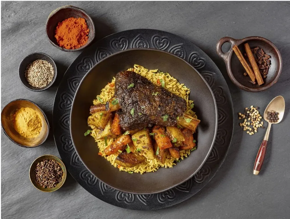 Beef shank served on saffron rice